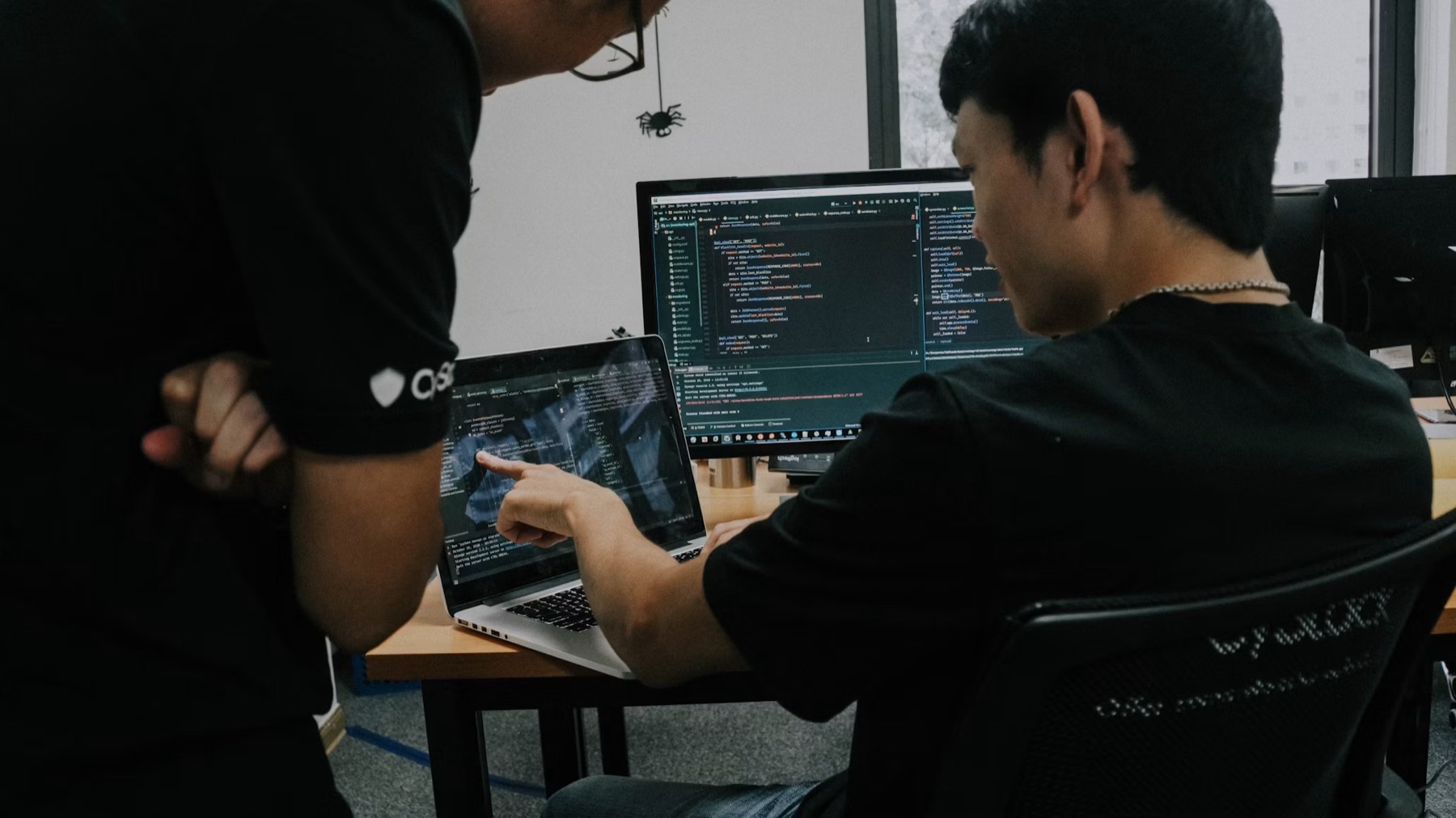 Two engineers reviewing code together